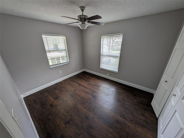 2564 SE 15th Ave Unit G, Ocala, FL 34471 - empty room with plenty of natural light, a ceiling fan, dark wood-type flooring, and a textured ceiling