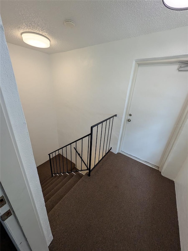 2564 SE 15th Ave Unit G, Ocala, FL 34471 - stairs featuring carpet floors and a textured ceiling
