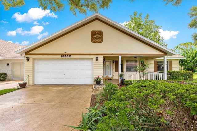 8530 SW 92nd St Unit D, Ocala, FL 34481 - view of front of house with covered porch, driveway, and a garage