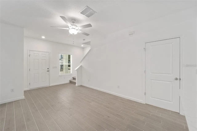 3409 SW 34th Ave Circle Unit 5, Ocala, FL 34474 - empty room with stairs, a ceiling fan, wood finished floors, and recessed lighting