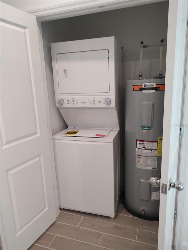 3409 SW 34th Ave Circle Unit 5, Ocala, FL 34474 - washroom with stacked washer and clothes dryer, water heater, and wood tiled floors