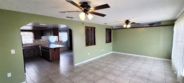 406WRIGHTST Wright St, Inverness, FL 34452 - kitchen with a textured ceiling, a ceiling fan, arched walkways, and light tile patterned floors