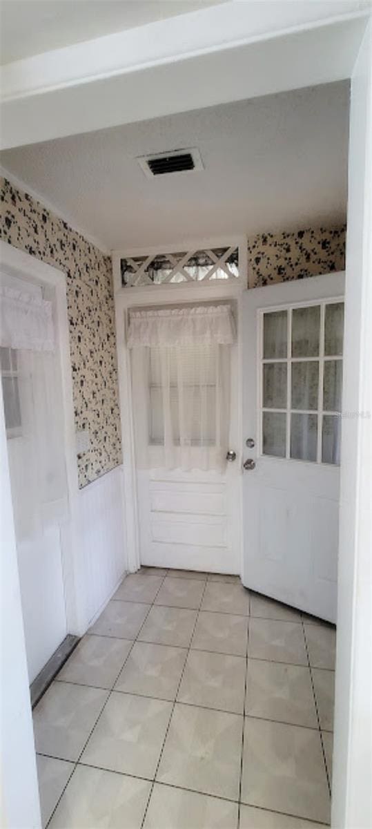 406WRIGHTST Wright St, Inverness, FL 34452 - hall featuring a wainscoted wall, wallpapered walls, and light tile patterned floors