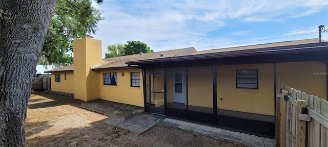 406WRIGHTST Wright St, Inverness, FL 34452 - back of house with a sunroom, a chimney, and stucco siding