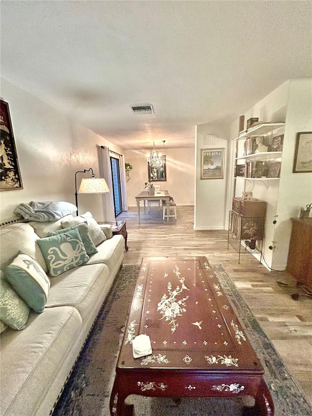 2214 NE 45th Ave Unit 3, Ocala, FL 34470 - living room with wood finished floors and a chandelier