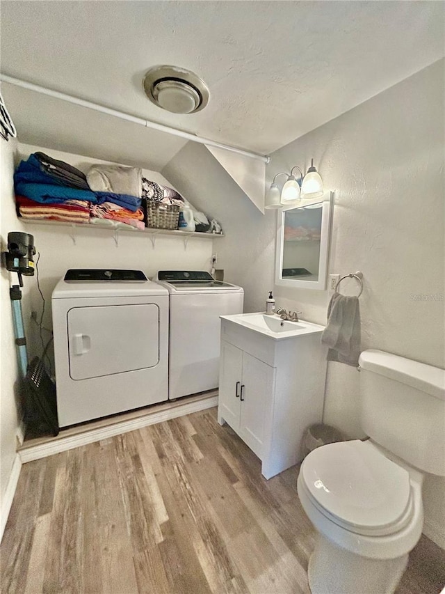 2214 NE 45th Ave Unit 3, Ocala, FL 34470 - half bathroom featuring separate washer and dryer, wood finished floors, vanity, and a textured ceiling