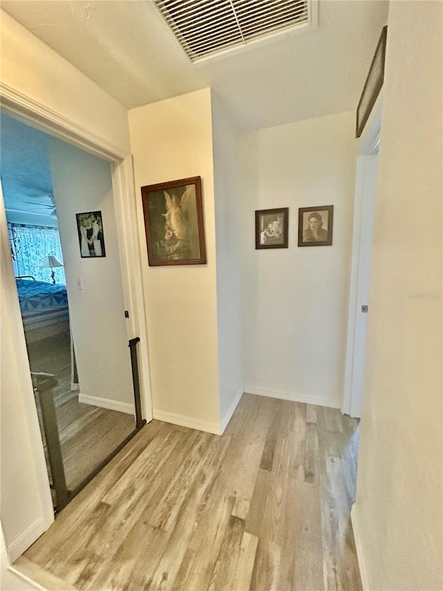 2214 NE 45th Ave Unit 3, Ocala, FL 34470 - corridor with light wood-style flooring and an upstairs landing