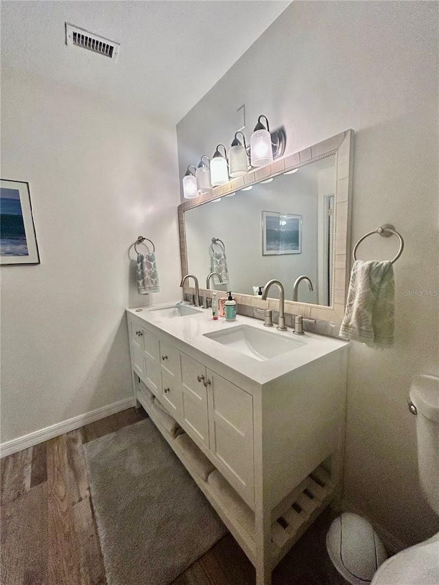 2214 NE 45th Ave Unit 3, Ocala, FL 34470 - full bathroom featuring wood finished floors and double vanity