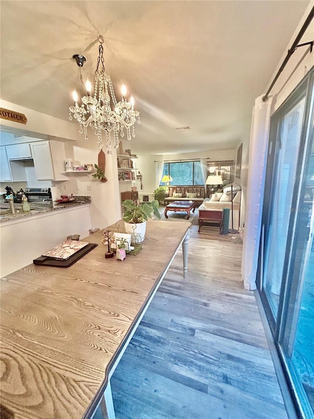 2214 NE 45th Ave Unit 3, Ocala, FL 34470 - dining area featuring wood finished floors and a chandelier
