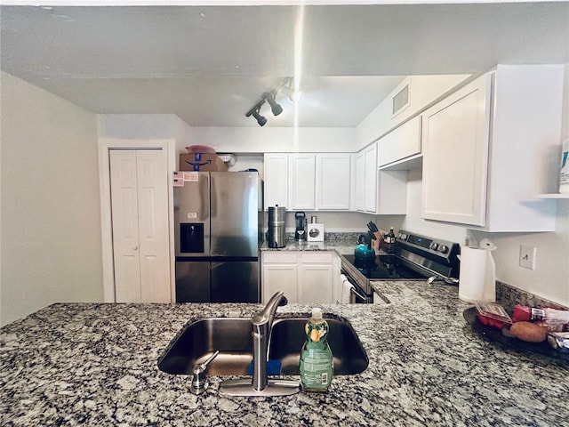 2214 NE 45th Ave Unit 3, Ocala, FL 34470 - kitchen featuring appliances with stainless steel finishes, stone countertops, white cabinets, and rail lighting
