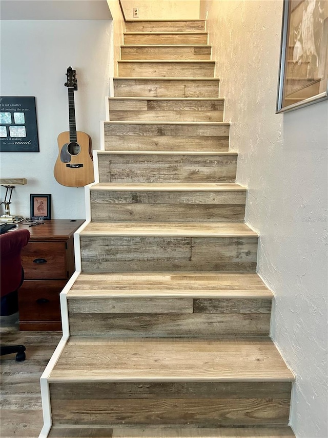 2214 NE 45th Ave Unit 3, Ocala, FL 34470 - stairway featuring a textured wall and wood finished floors