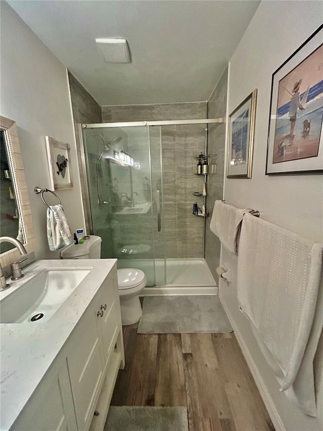 2214 NE 45th Ave Unit 3, Ocala, FL 34470 - full bath with wood finished floors, vanity, and a shower stall