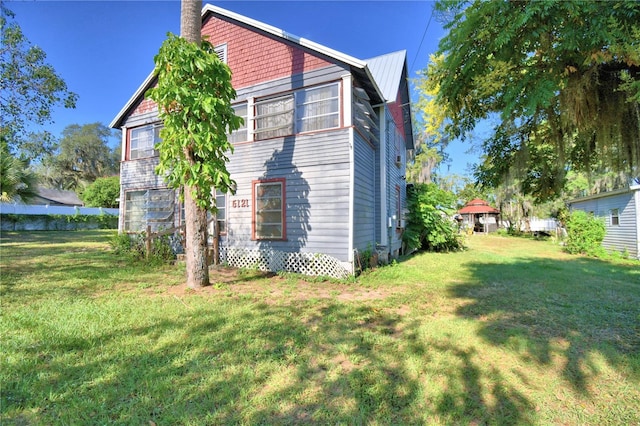 view of home's exterior with a yard