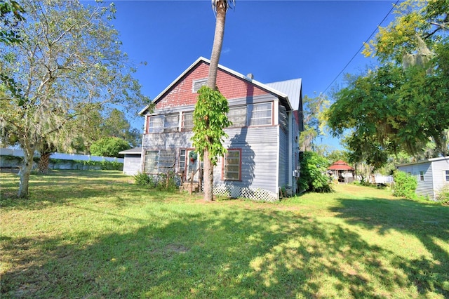 rear view of house with a yard