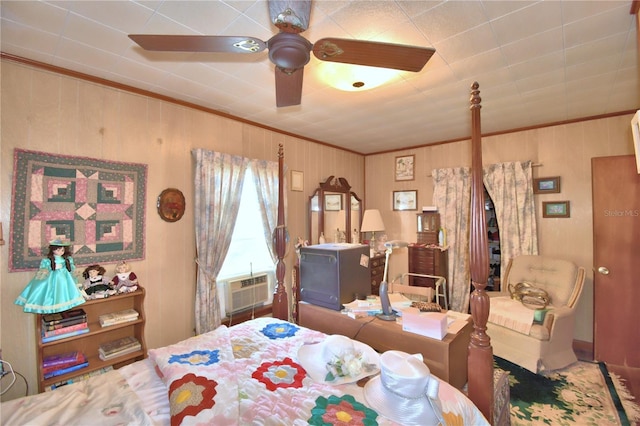 bedroom with ceiling fan, cooling unit, wood walls, and ornamental molding