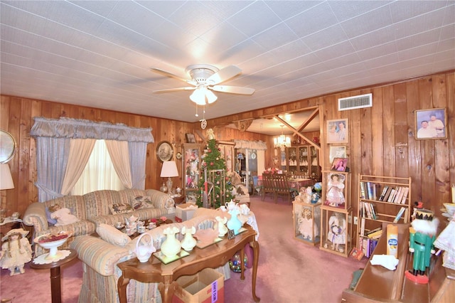 living room featuring carpet flooring and ceiling fan with notable chandelier