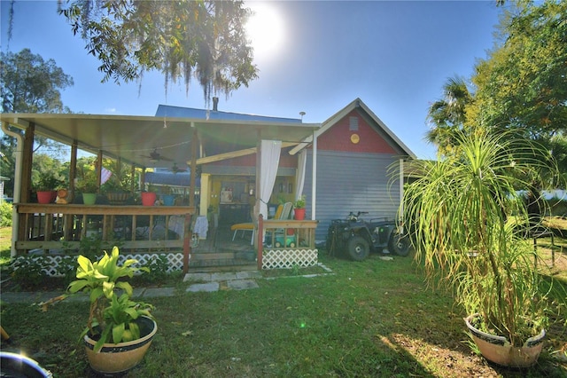 back of house featuring a yard