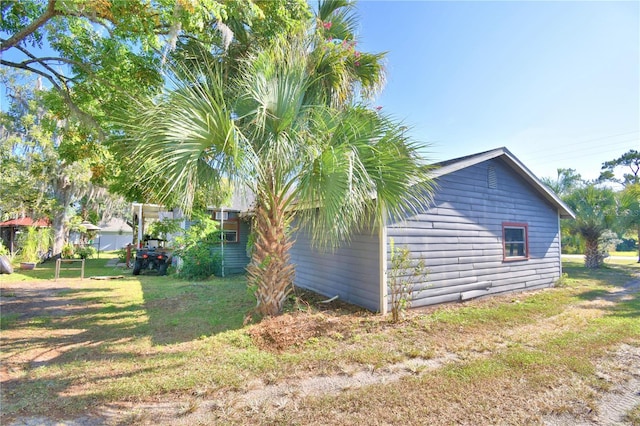 view of side of property featuring a yard