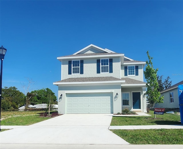 front facade with a front yard and a garage