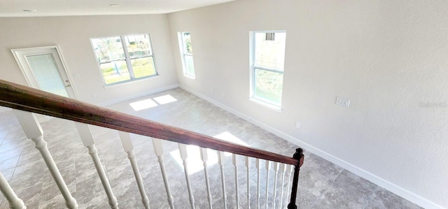 stairs with a healthy amount of sunlight and vaulted ceiling