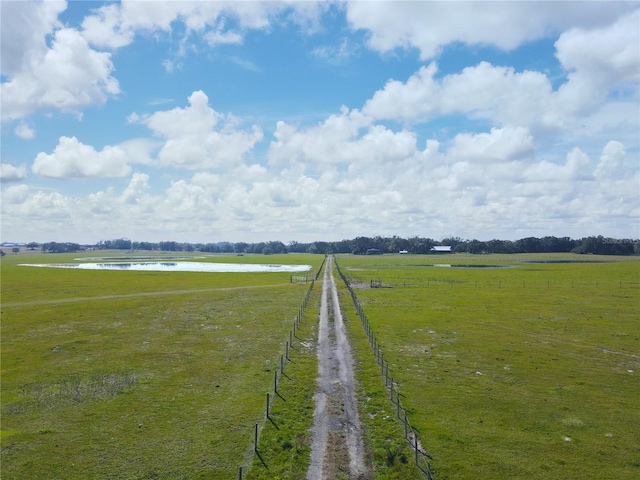 view of yard with a rural view and a water view