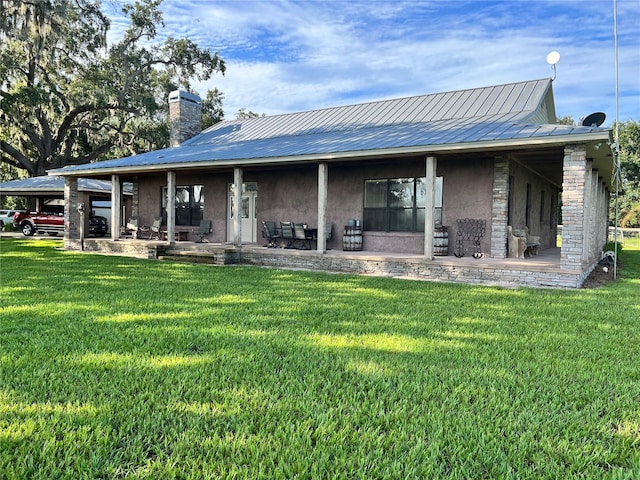 back of house with a lawn