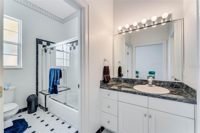 full bathroom featuring shower / bath combination with glass door, vanity, and toilet