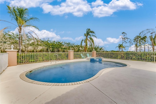 view of swimming pool with a patio and an in ground hot tub