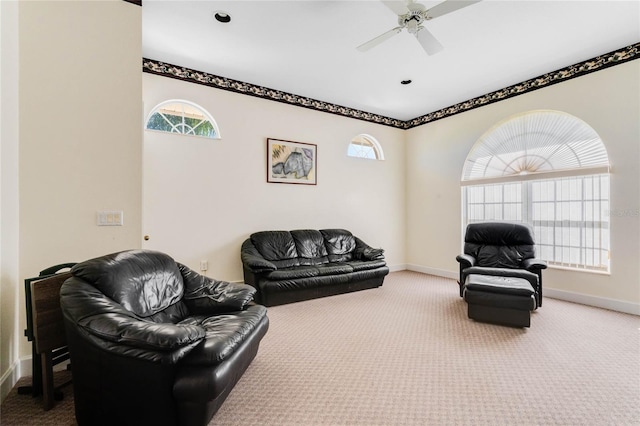 carpeted living room with ceiling fan