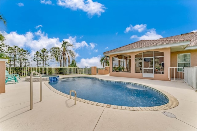 view of pool with a patio area and an in ground hot tub