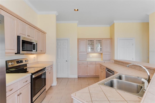 kitchen featuring appliances with stainless steel finishes, sink, tile countertops, and light brown cabinetry