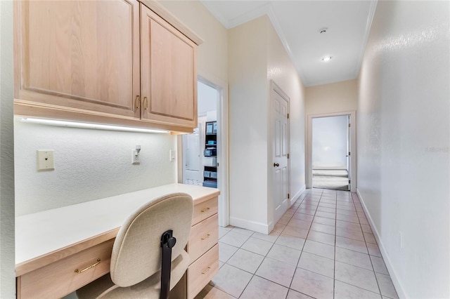 hall featuring ornamental molding and light tile patterned floors