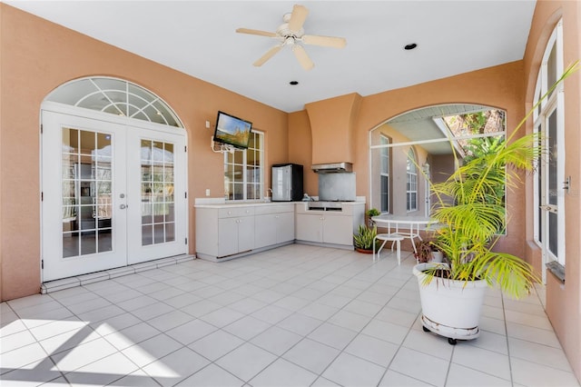 interior space with french doors, area for grilling, and ceiling fan