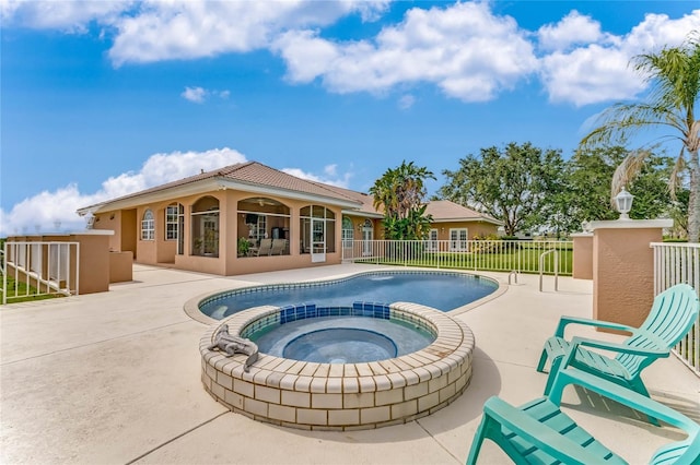 view of pool featuring an in ground hot tub and a patio