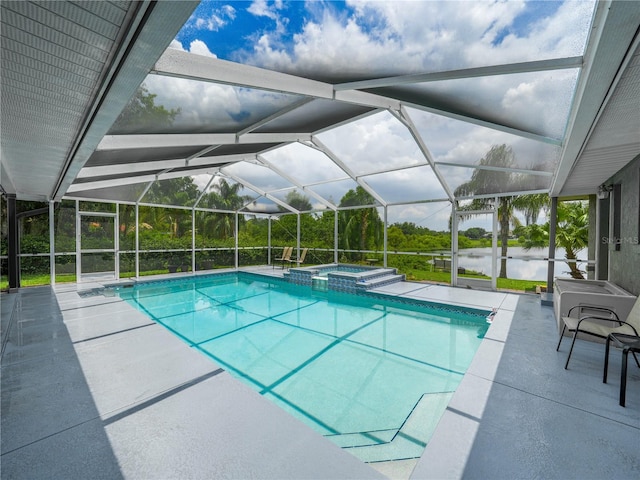 view of pool featuring a patio area, an in ground hot tub, and a lanai
