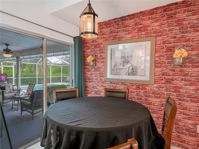 dining room with brick wall and ceiling fan