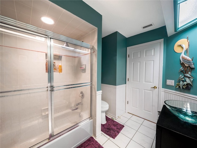 full bathroom with enclosed tub / shower combo, toilet, tile floors, and vanity