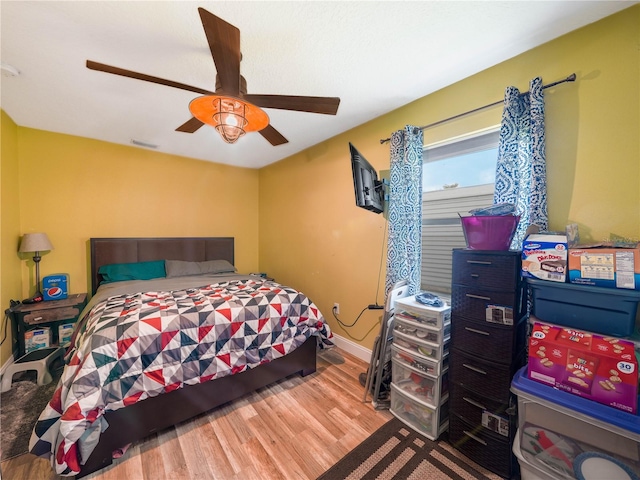 bedroom with ceiling fan and light wood-type flooring