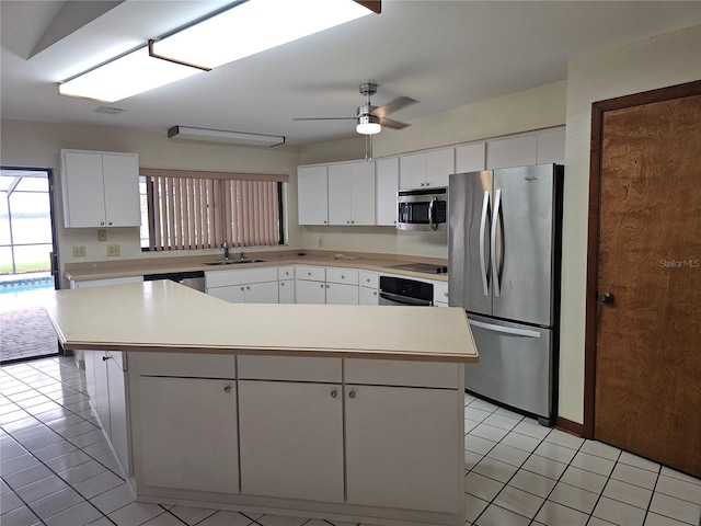 kitchen with white cabinetry, a center island, sink, ceiling fan, and appliances with stainless steel finishes