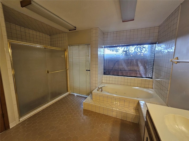 bathroom with plus walk in shower, tile patterned flooring, and vanity