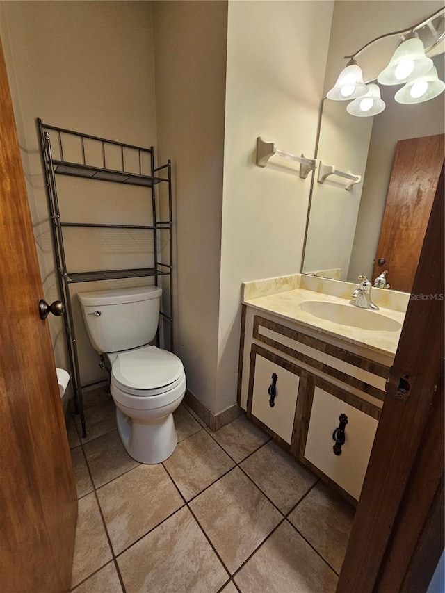 bathroom featuring vanity, toilet, and tile patterned floors
