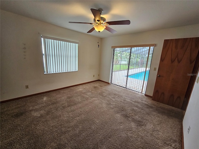 carpeted spare room with ceiling fan