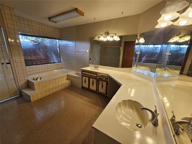 bathroom with tile patterned flooring, separate shower and tub, and vanity