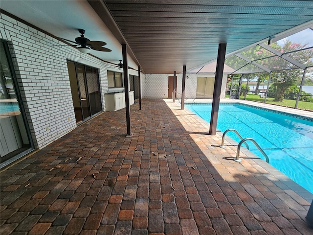 view of swimming pool with a lanai, ceiling fan, and a patio