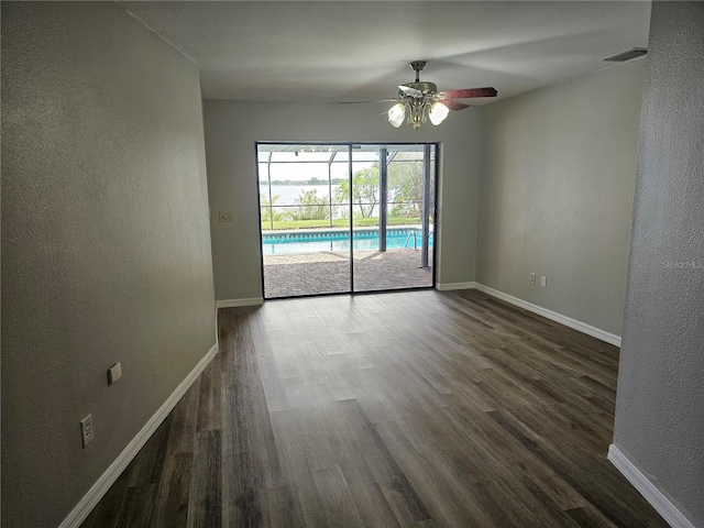 unfurnished room with dark hardwood / wood-style flooring and ceiling fan