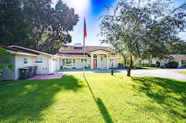 view of front of house with a front yard and solar panels