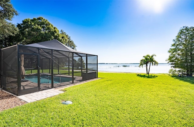 exterior space with glass enclosure and a water view