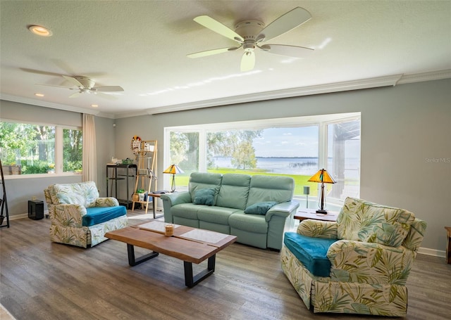 living room with ceiling fan, wood-type flooring, and crown molding