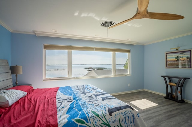 bedroom with crown molding, ceiling fan, dark hardwood / wood-style flooring, and a water view