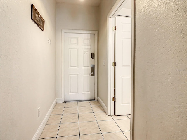 doorway with light tile floors